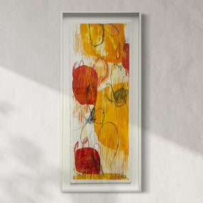 Vertical framed artwork featuring abstract elements in red, yellow, and black colors on a white background, displayed on a wall.