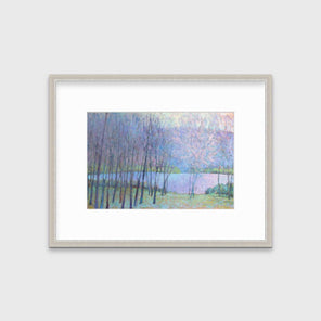 A blue, green and purple abstract landscape print in a silver frame with a mat hangs on a white wall.