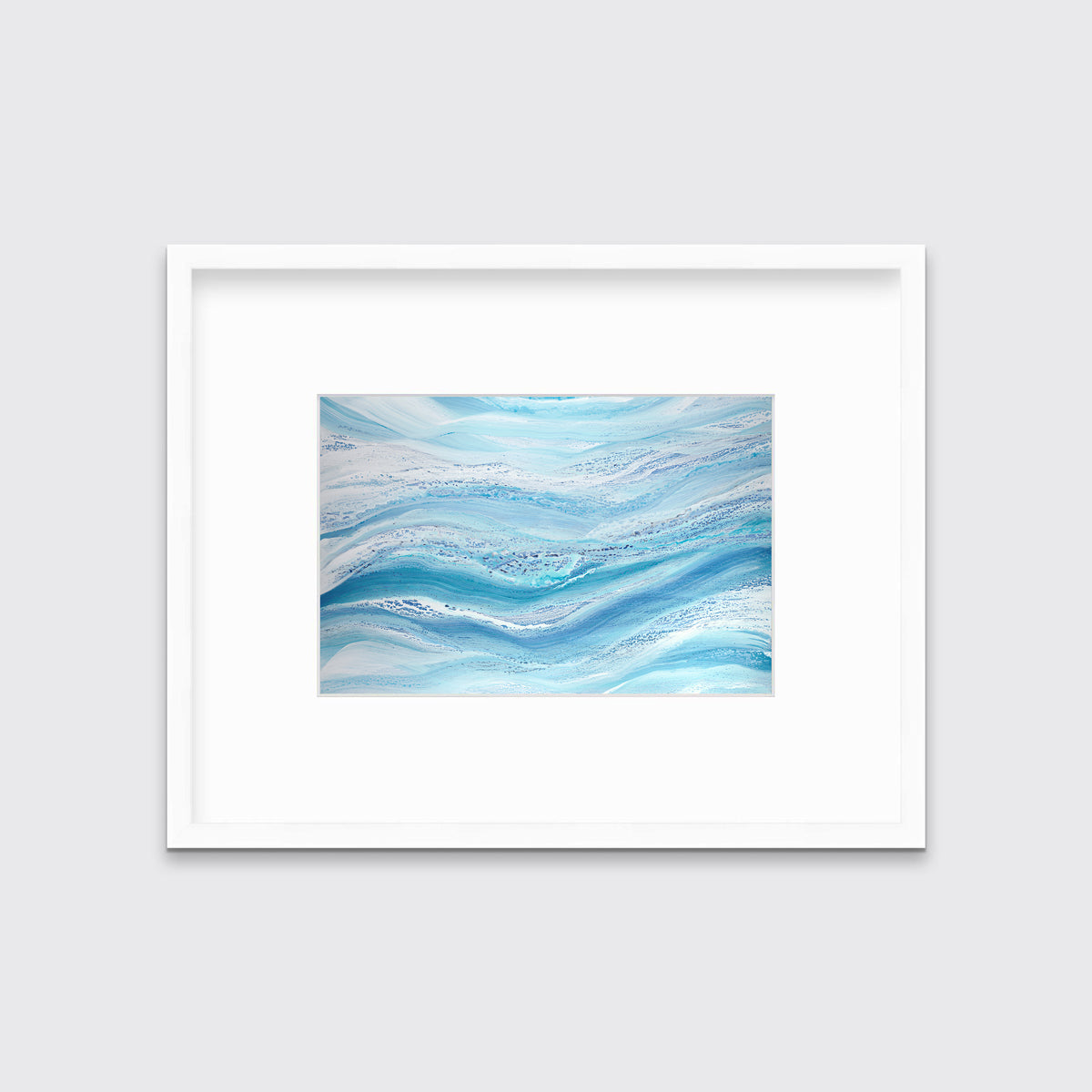 A blue, teal and white abstract print in a white frame with a mat hangs on a white wall.