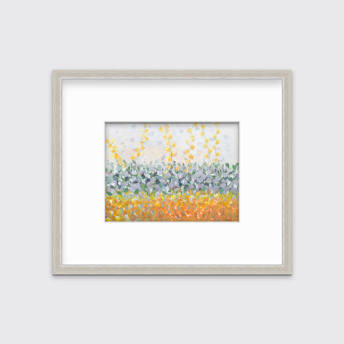 A yellow, purple, green and orange abstract print in a silver frame with a mat hangs on a white wall.