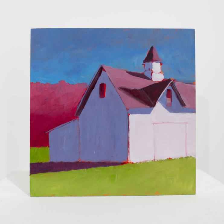 A pink, blue, and green contemporary landscape painting sits upright on a white table surface in front of a white wall.