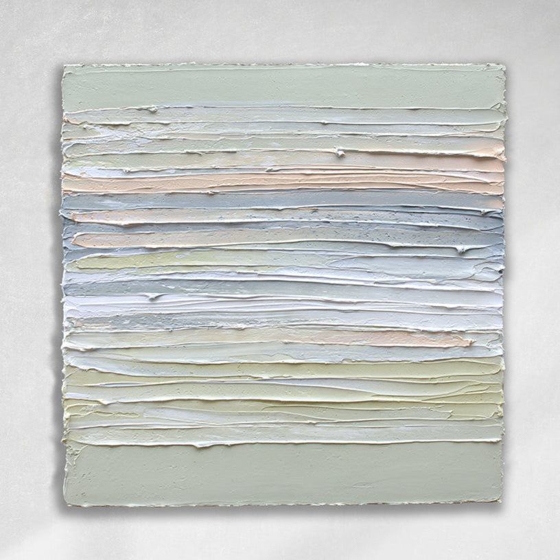 A sage green, grey, white, celadon and peach thickly textured painting hanging on a white wall by Teodora Guererra.
