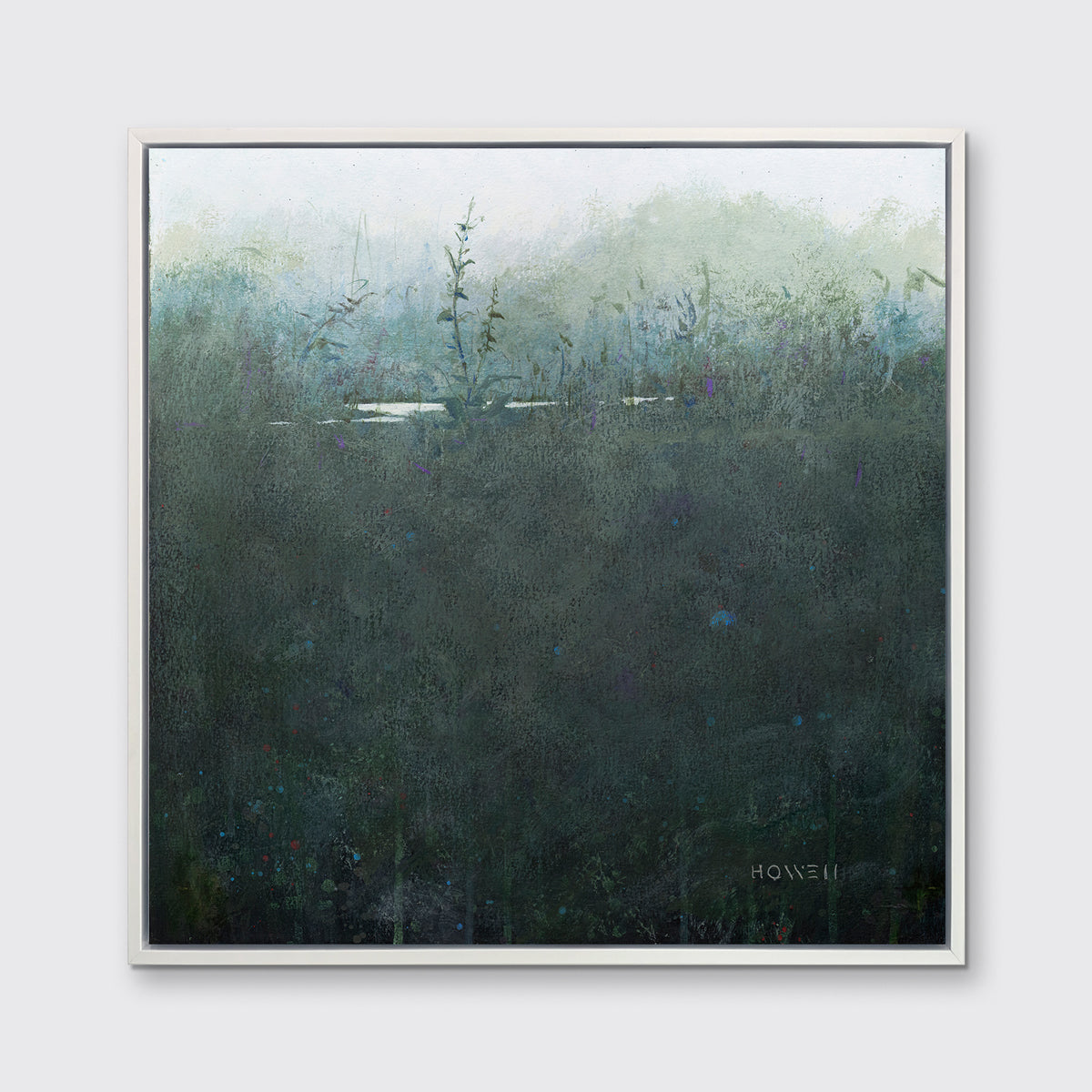 A dark muted teal abstract landscape print in a white floater frame hangs on a white wall.