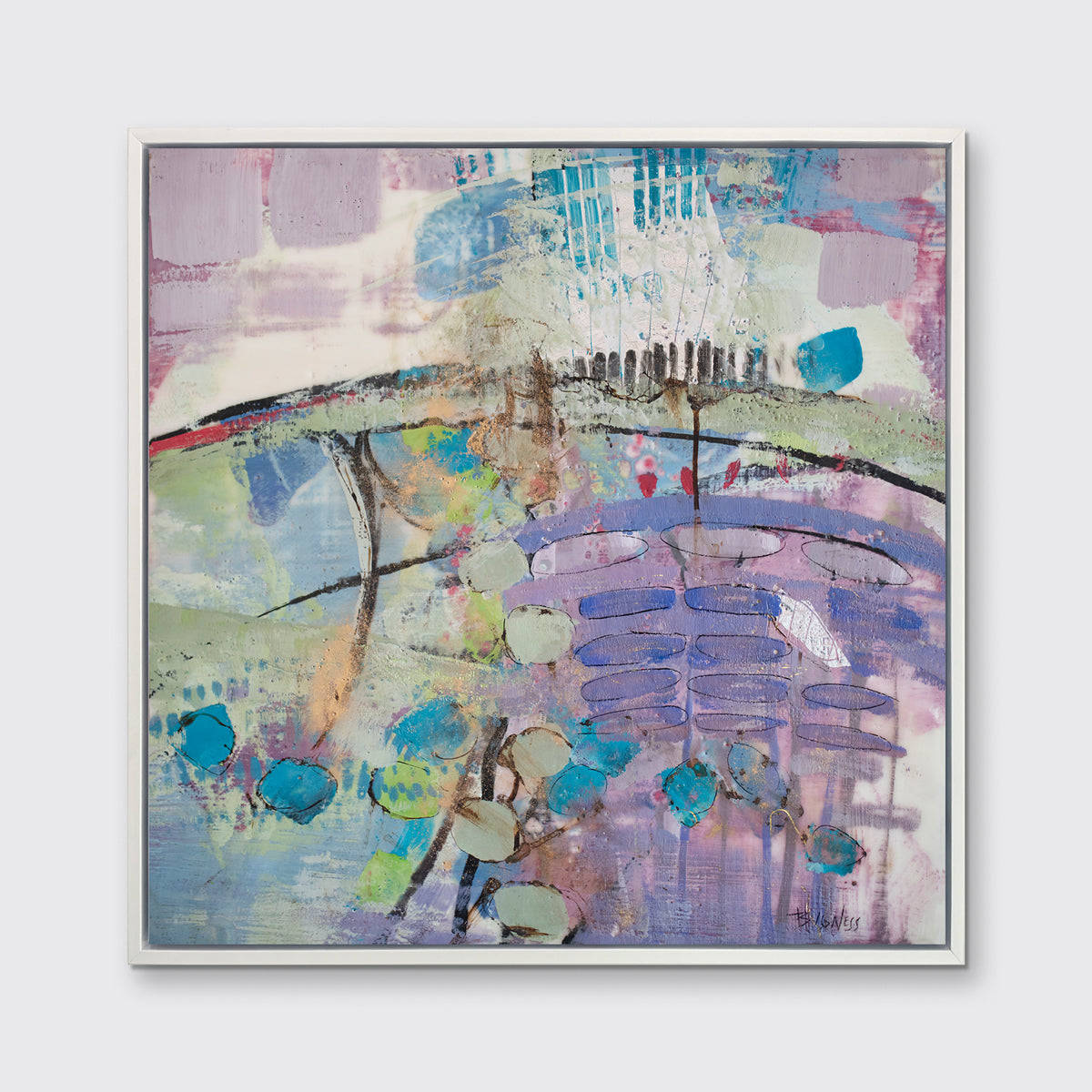 A multicolored abstract print framed in a white floater frame hangs on a light grey wall.