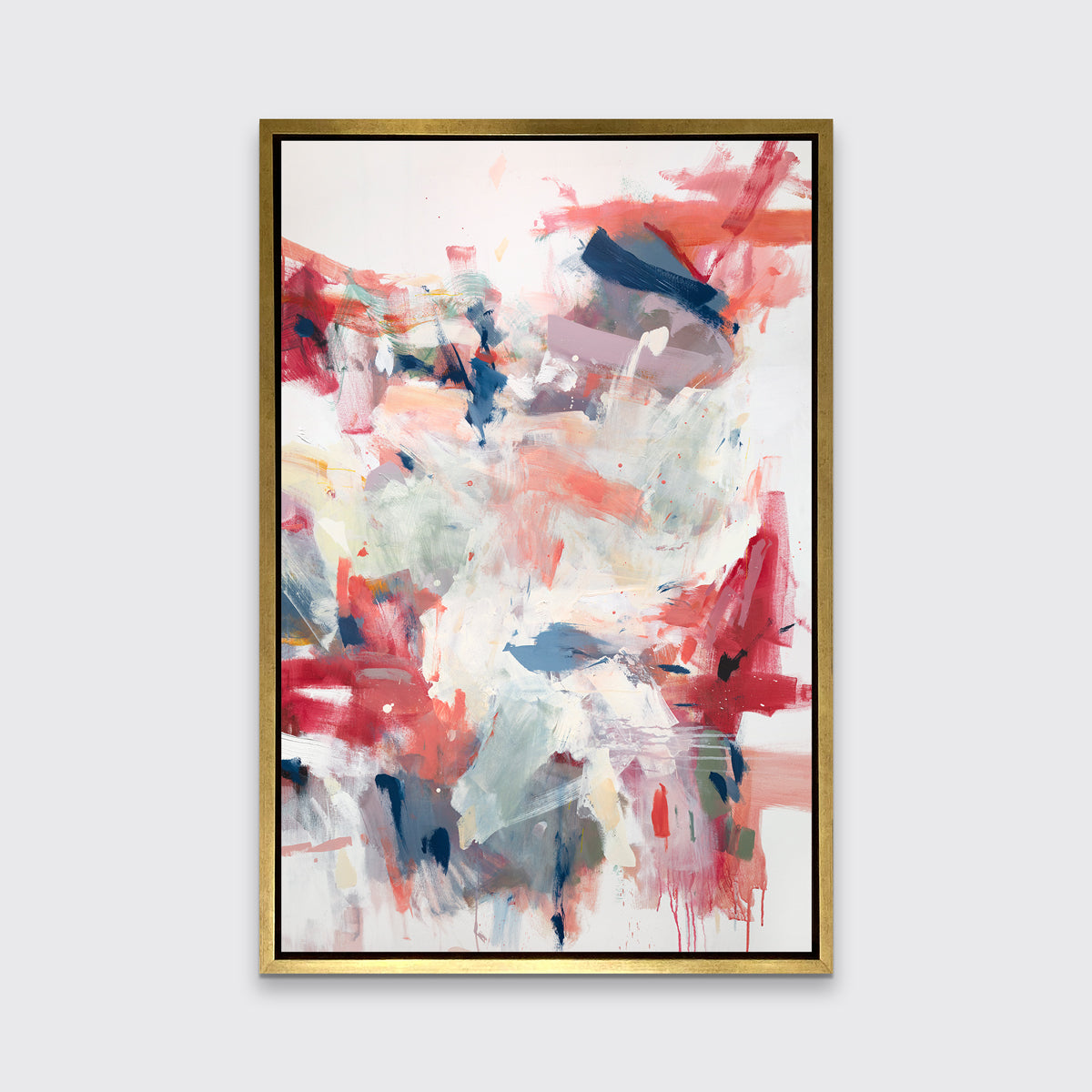 A pink, blue and white abstract print in a gold floater frame hangs on a white wall.