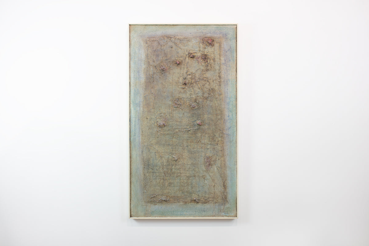 A green and brown abstract painting hangs on a white wall.