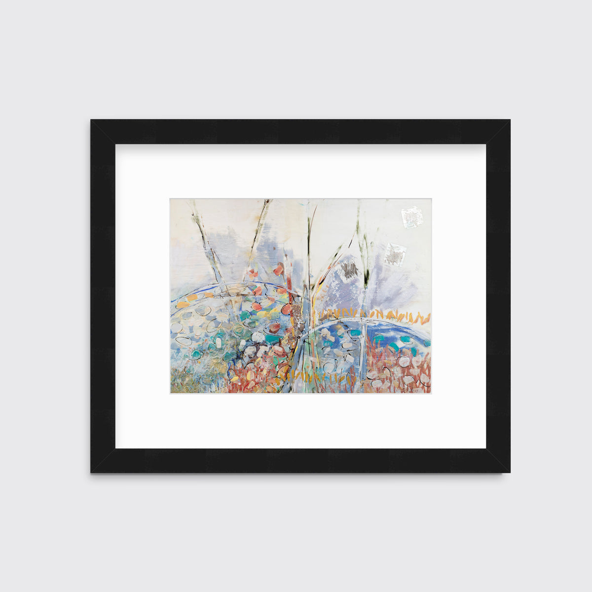 A multicolored abstract floral print in a black frame with a mat hangs on a white wall.