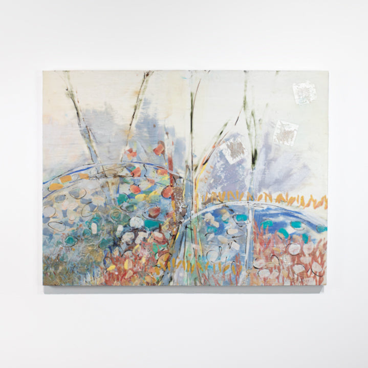 A multicolored abstract painting hangs on a white wall.