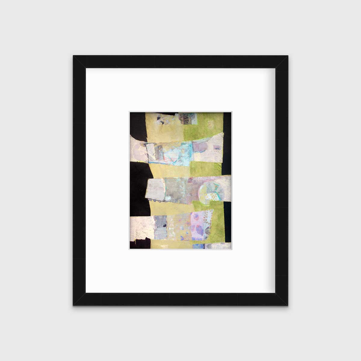 A green, black and beige abstract print by Christine Averill-Green in a black frame with a mat hangs on a white wall.