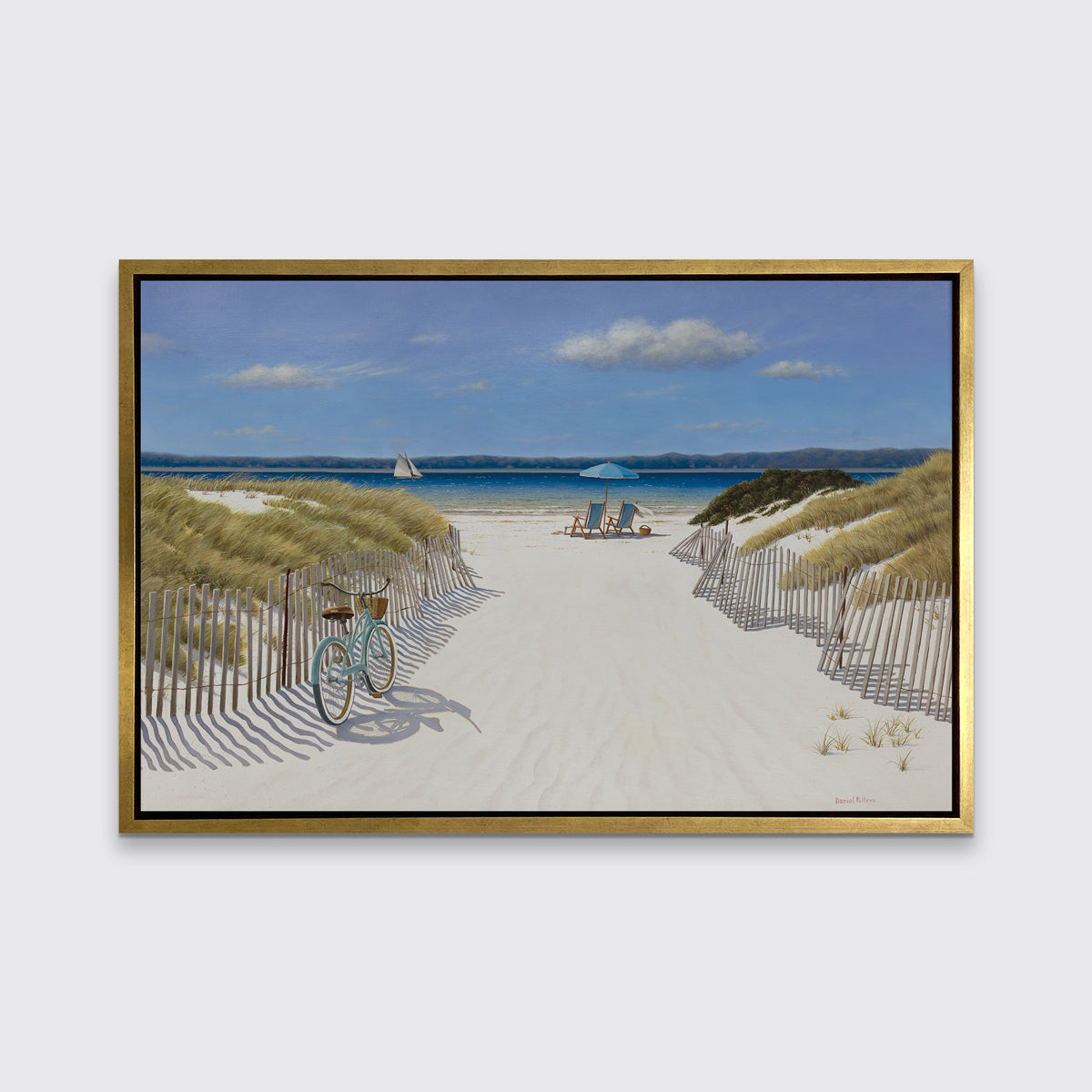 A blue, beige and light green contemporary seascape print in a gold floater frame hangs on a white wall.