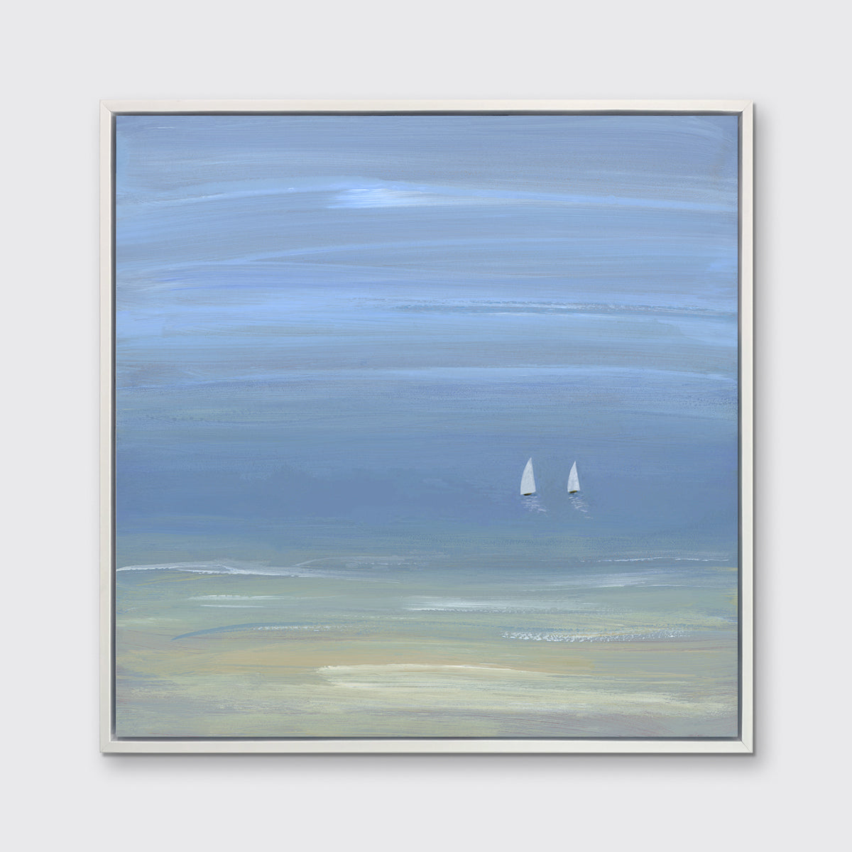 A blue, beige and white abstract seascape print with two small sailboats in a white floater frame hangs on a white wall.