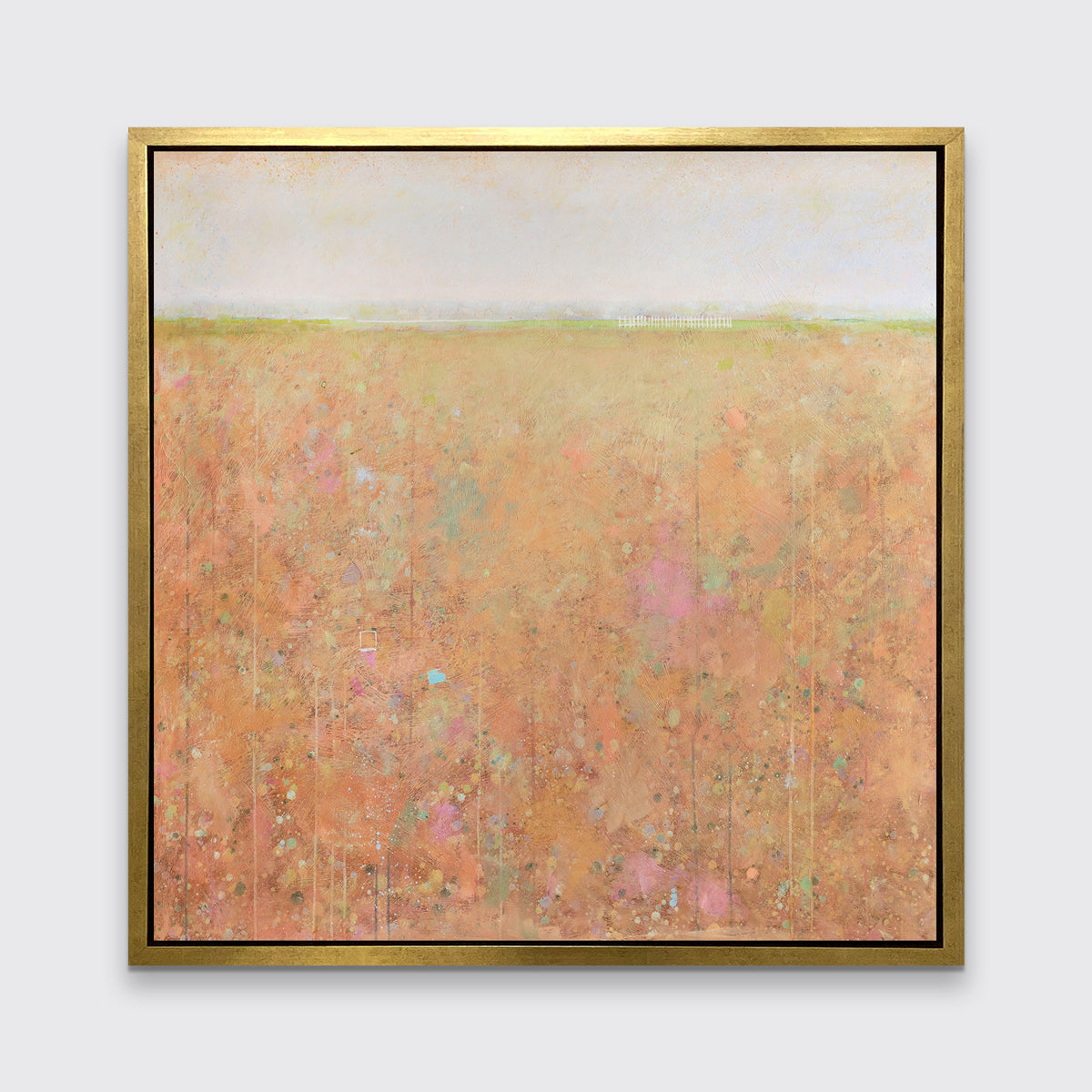 A orange, light green, light blue and pink abstract landscape print in a gold floater frame hangs on a white wall.