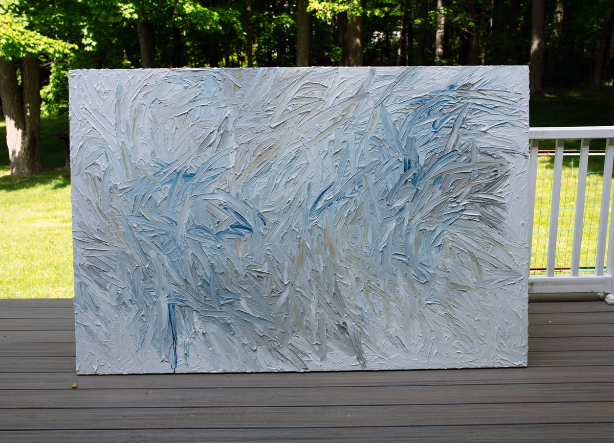 Abstract painting on a wooden deck with a natural background