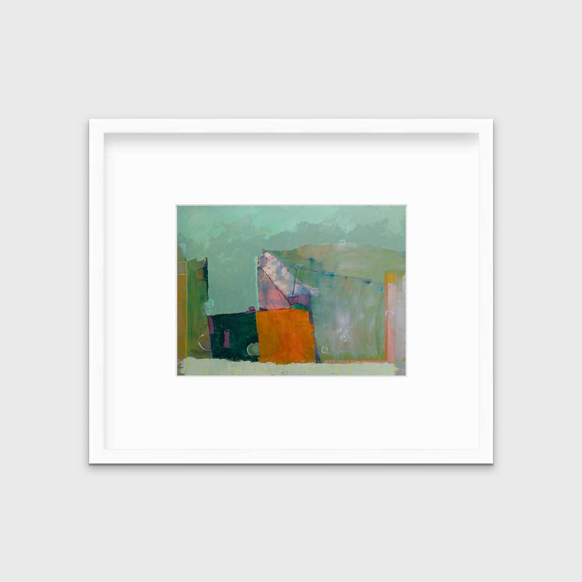 A green abstract print in a white frame with a mat hangs on a white wall.