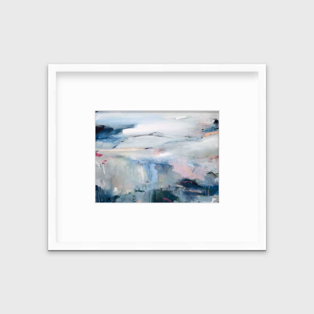 A blue abstract print in a white frame with a mat hangs on a white wall.