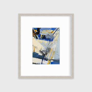 A blue, white, yellow and black abstract print in a silver frame with a mat hangs on a white wall.