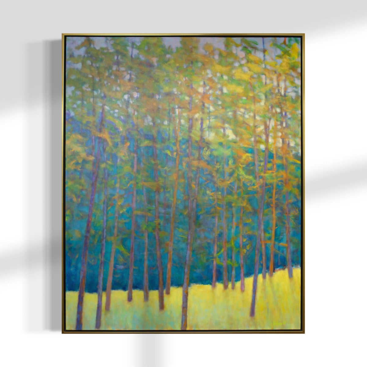 Framed painting of a forest scene with trees and blue sky.