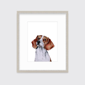 An illustration of a beagle dog framed in a silver frame hangs on a white wall. 