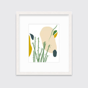 An abstract yellow, beige, blue, and green botanical art print framed in a white frame hangs on a light wall. 