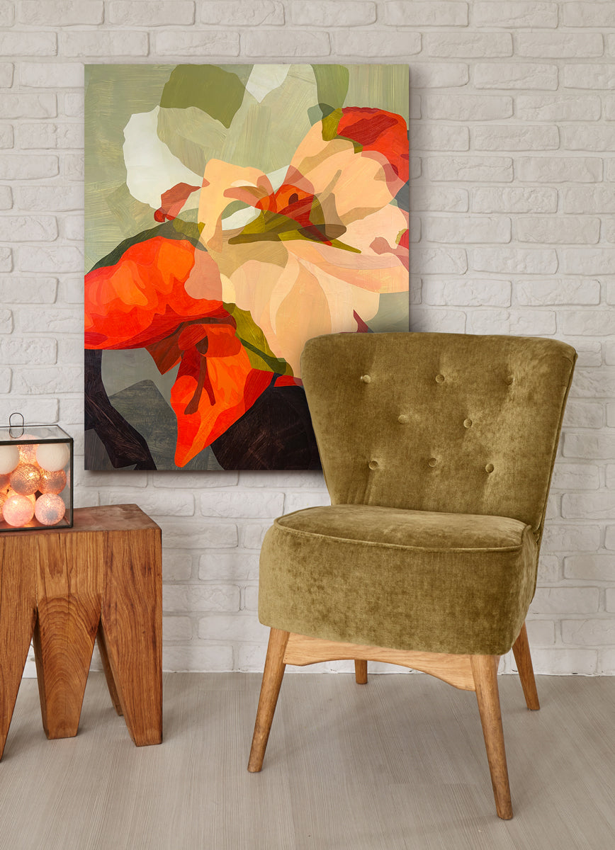 Green velvet chair in front of a colorful abstract painting on a white brick wall.