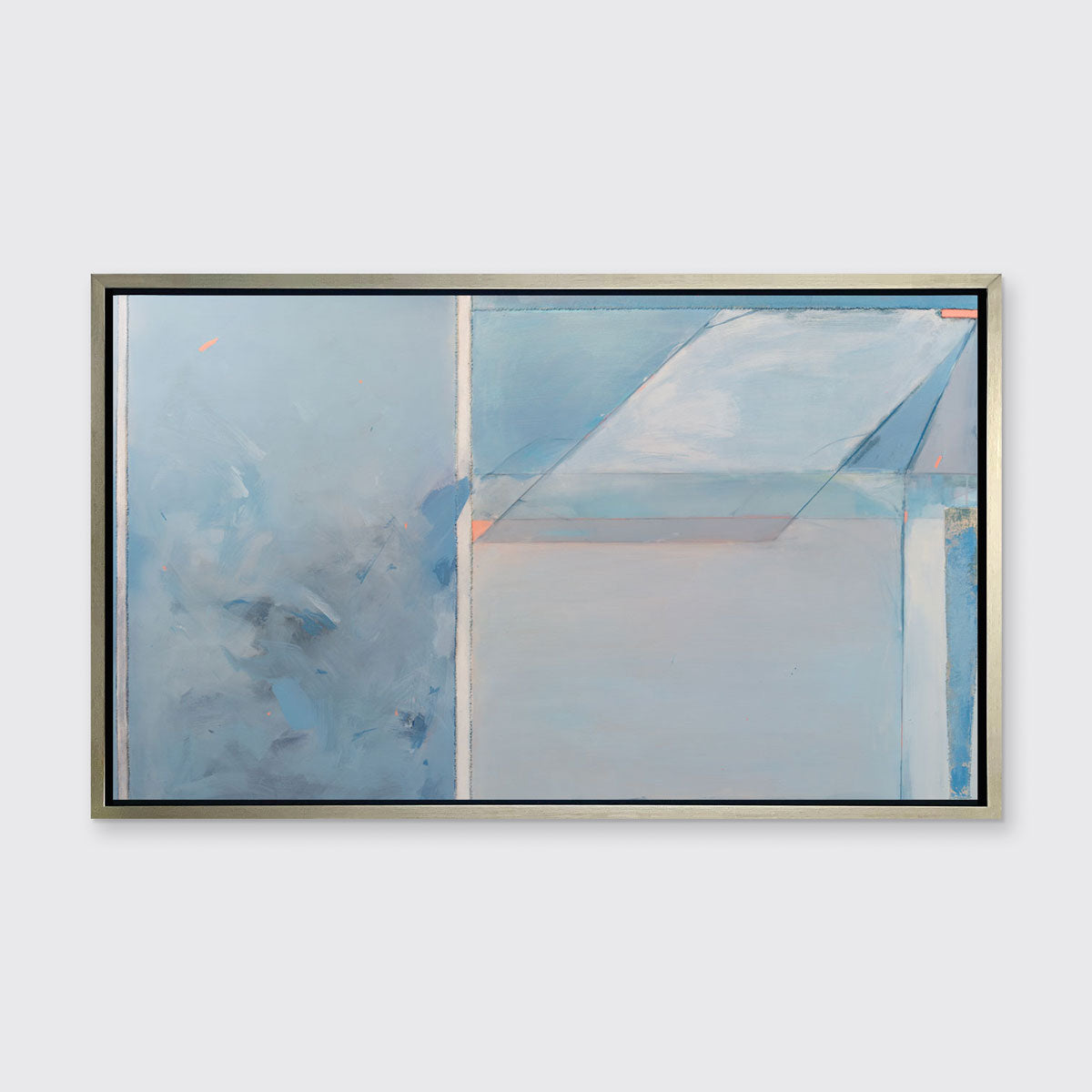 A blue, grey, and pink abstract art print by Kelly Rossetti framed in a silver floater frame hangs on a white wall.