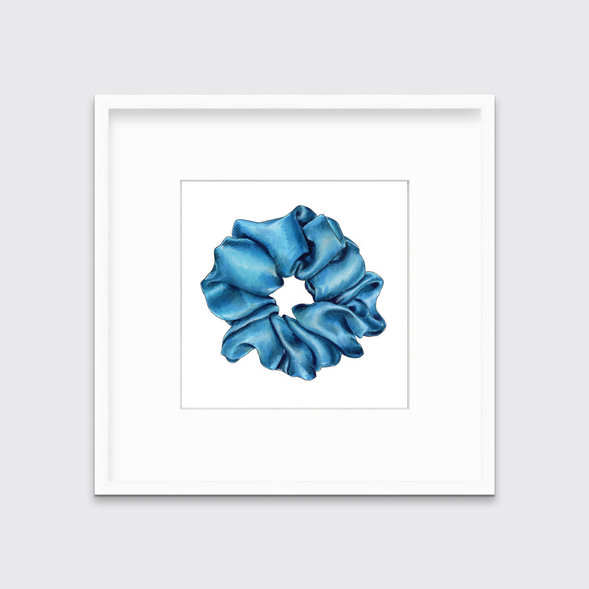 A drawing of a blue hair scrunchie framed in a white frame hangs on a white wall.