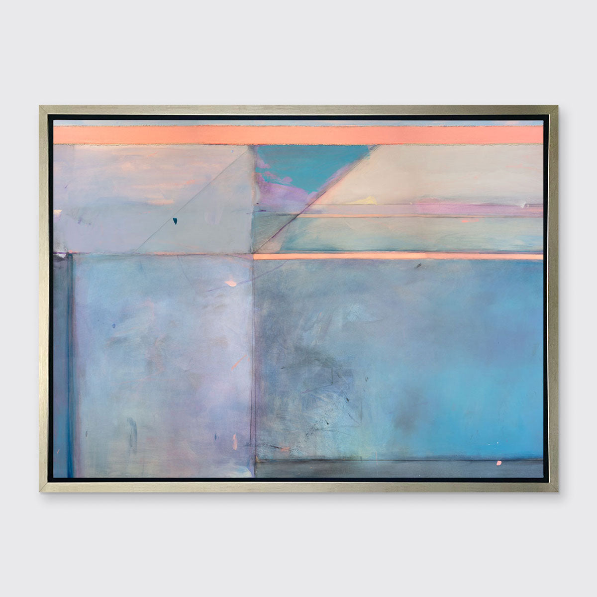 A pink and blue abstract print by Kelly Rossetti framed in a silver floater frame hangs on a white wall.