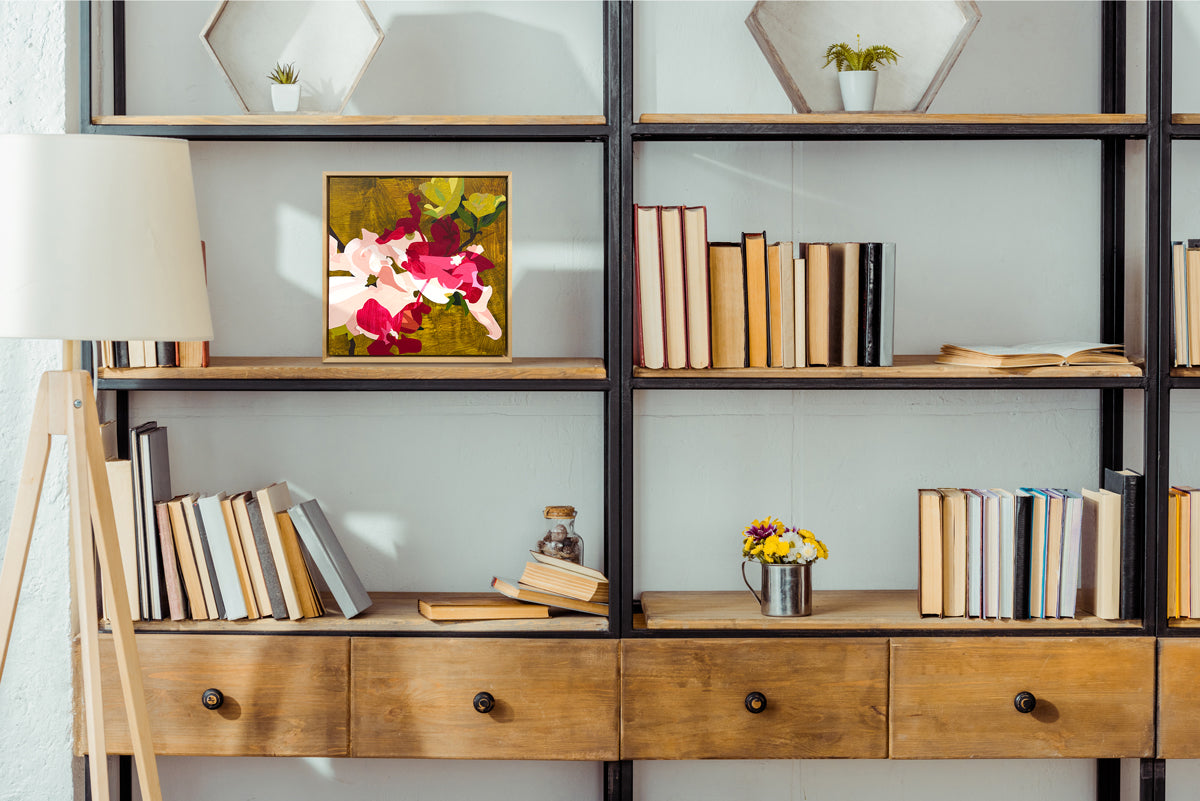 Bookshelf with books, a lamp, and decorative items against a light gray wall.