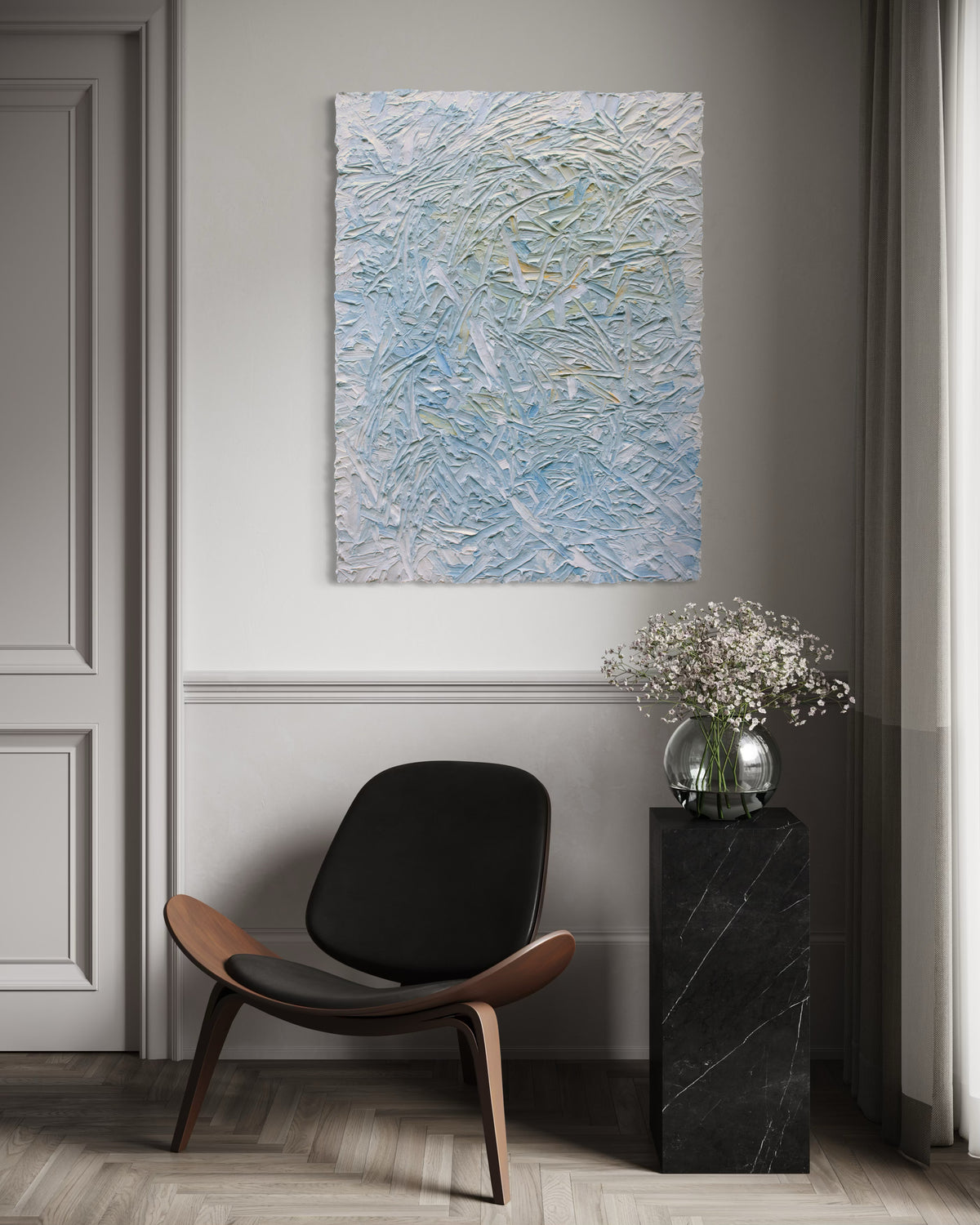 Abstract painting on a wall above a modern chair and side table with flowers.