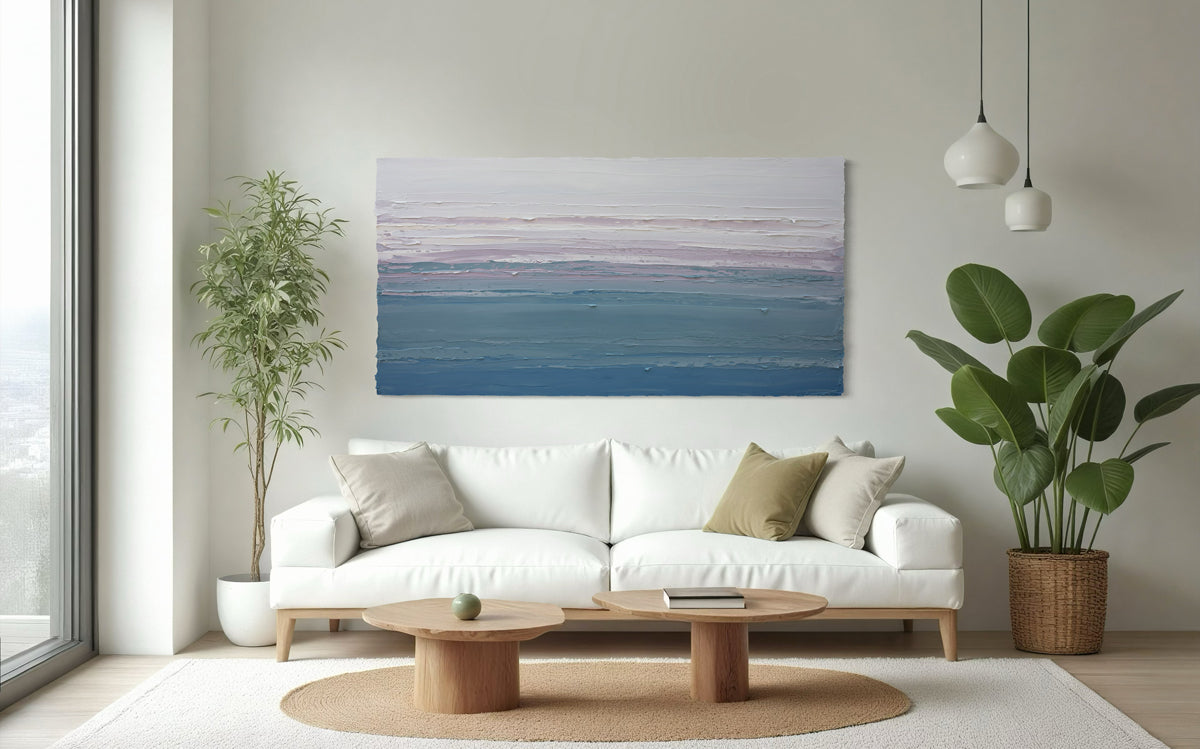 Modern living room with a white sofa, wooden coffee table, and an original abstract painting over the sofa.