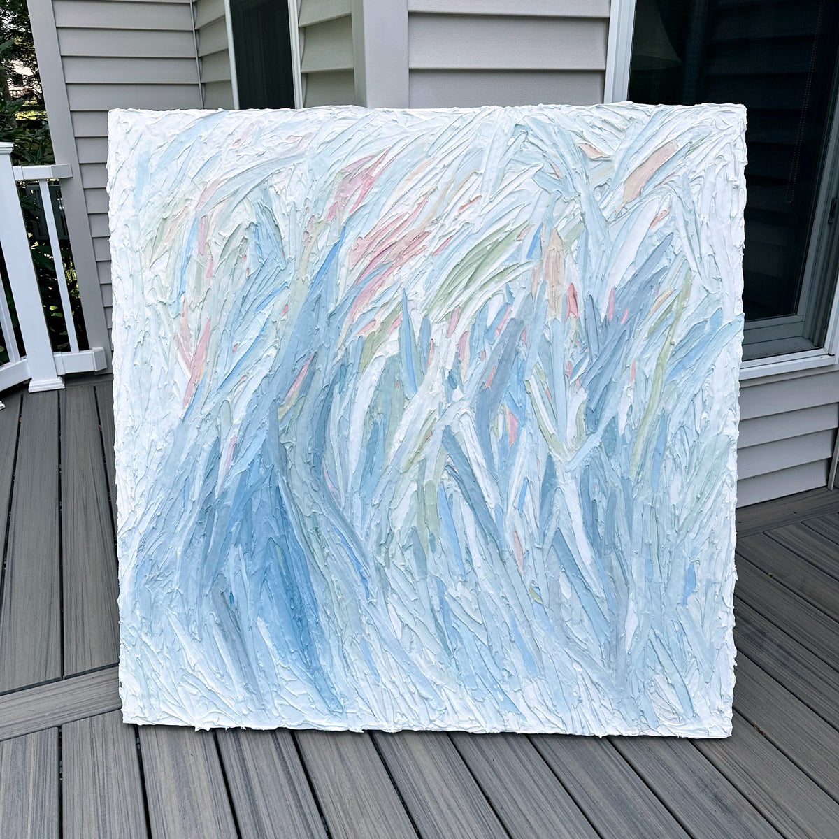 Original abstract painting by Teo Guererra on a wooden deck at her studio.