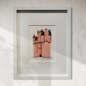Framed painting/illustration of a castle on a white wall