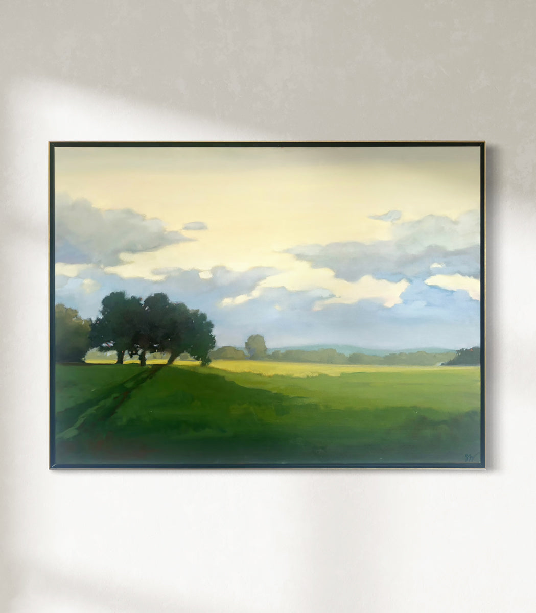 Framed painting of a landscape with trees and a sky.