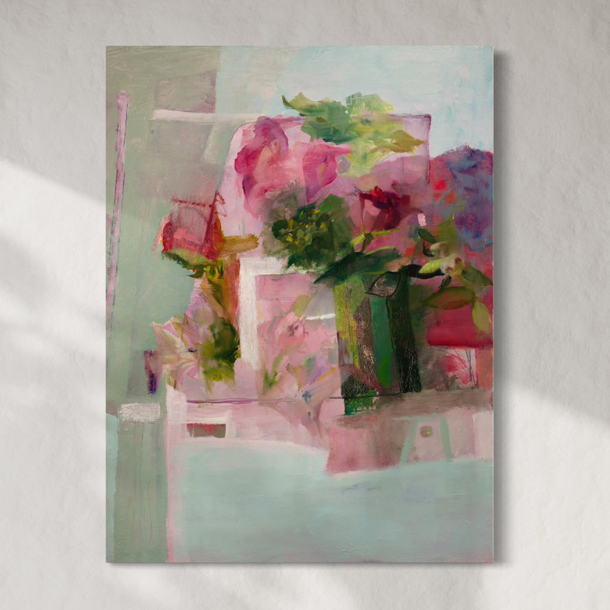 Original colorful abstract painting of flowers hanging on a white wall.