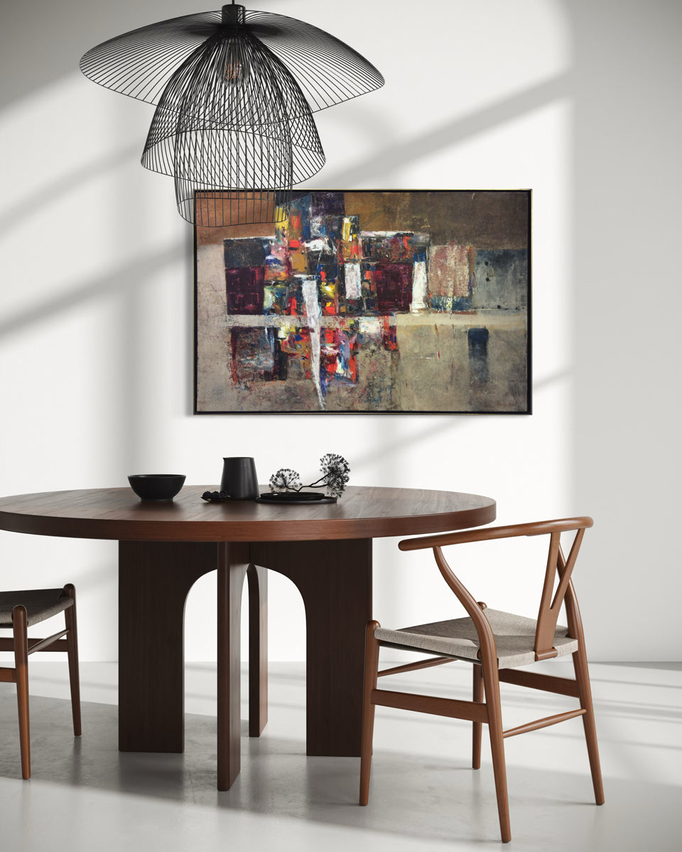 Dining room with wooden table, chairs, and abstract art on the wall.
