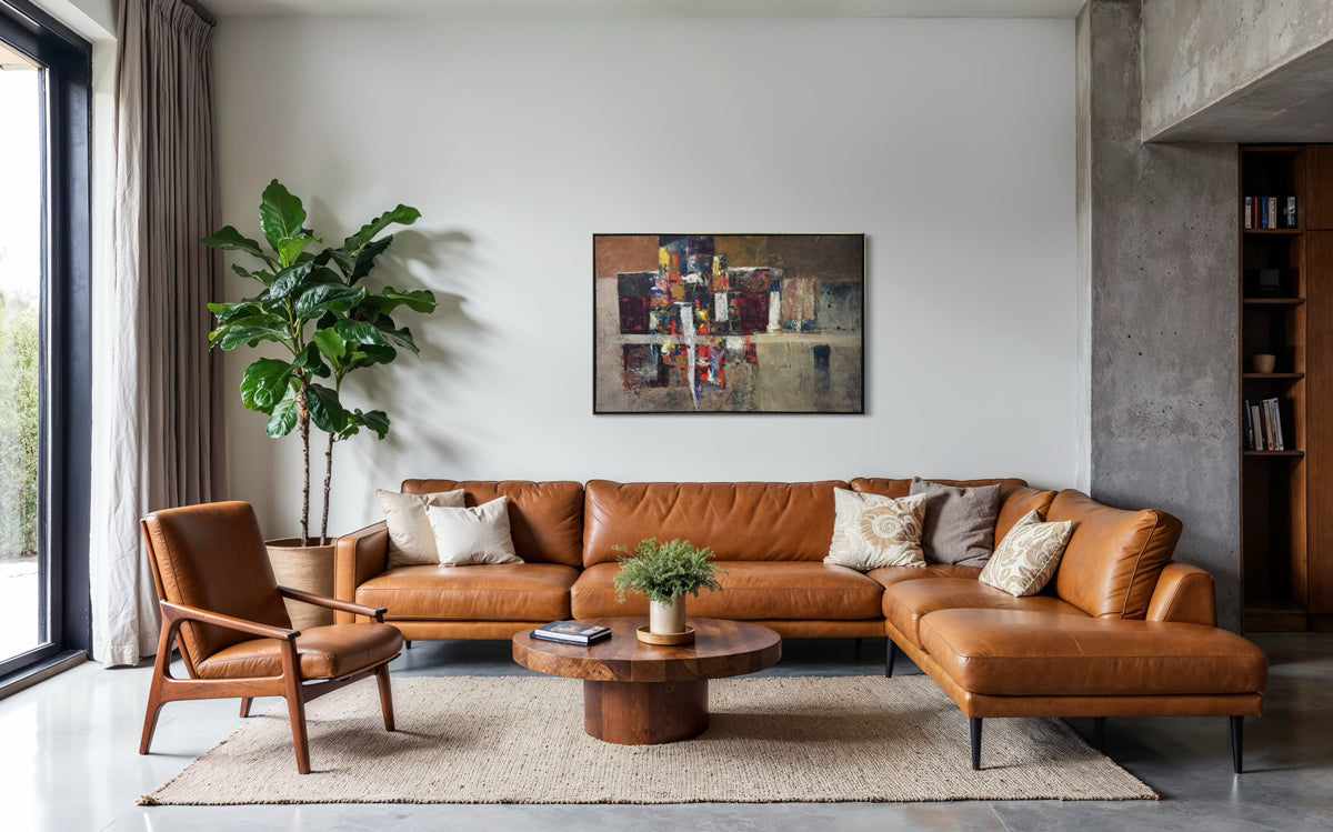 Modern living room with brown leather sectional sofa, wooden armchair, and abstract painting on wall.