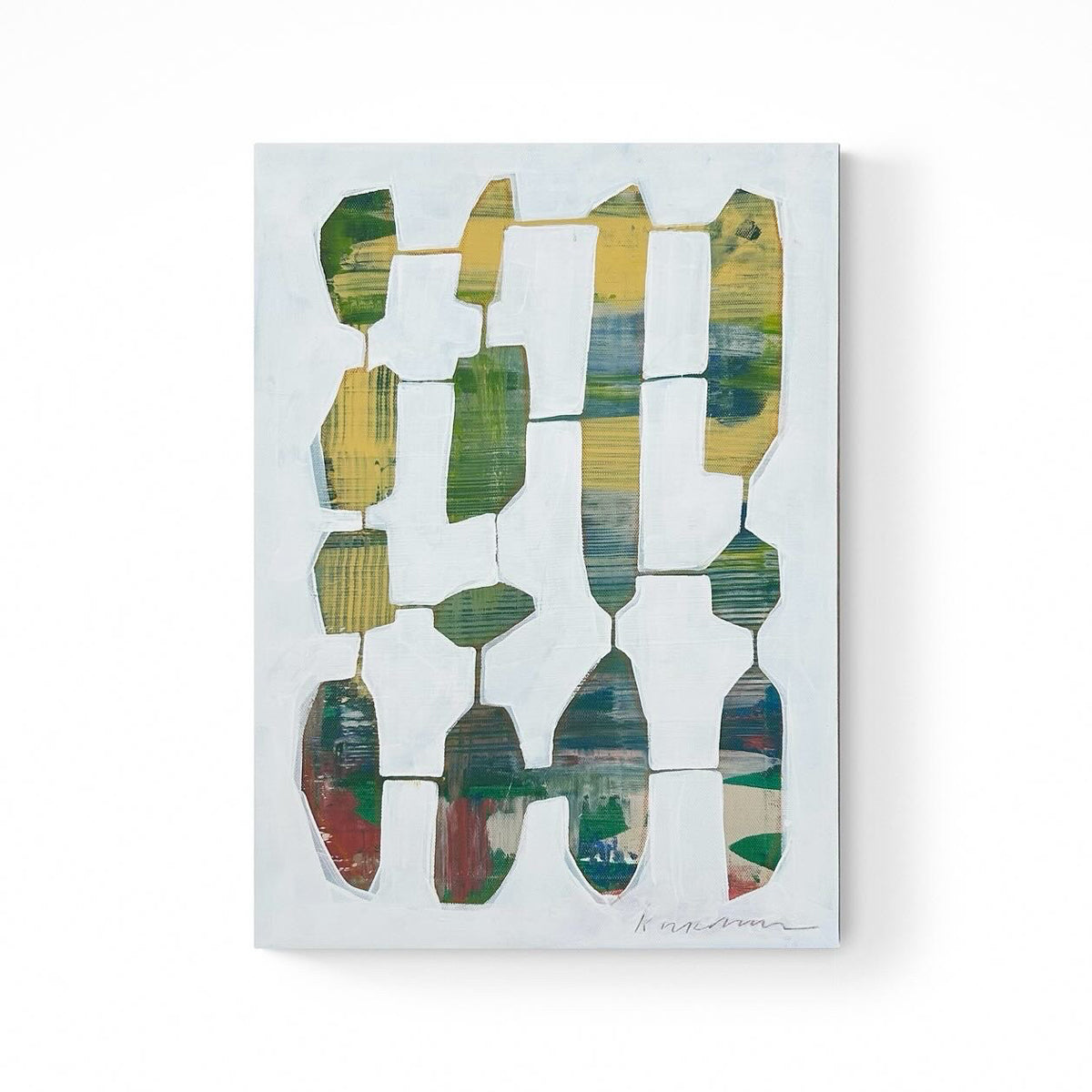 An abstract painting featuring geometric shapes in various colors displayed on a wall.