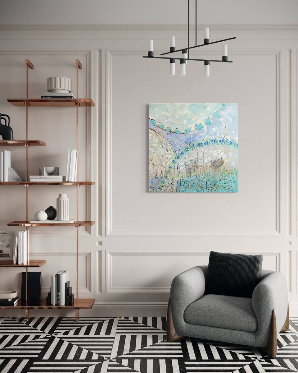 Modern living room with a gray armchair, bookshelf, and abstract painting on a white wall.