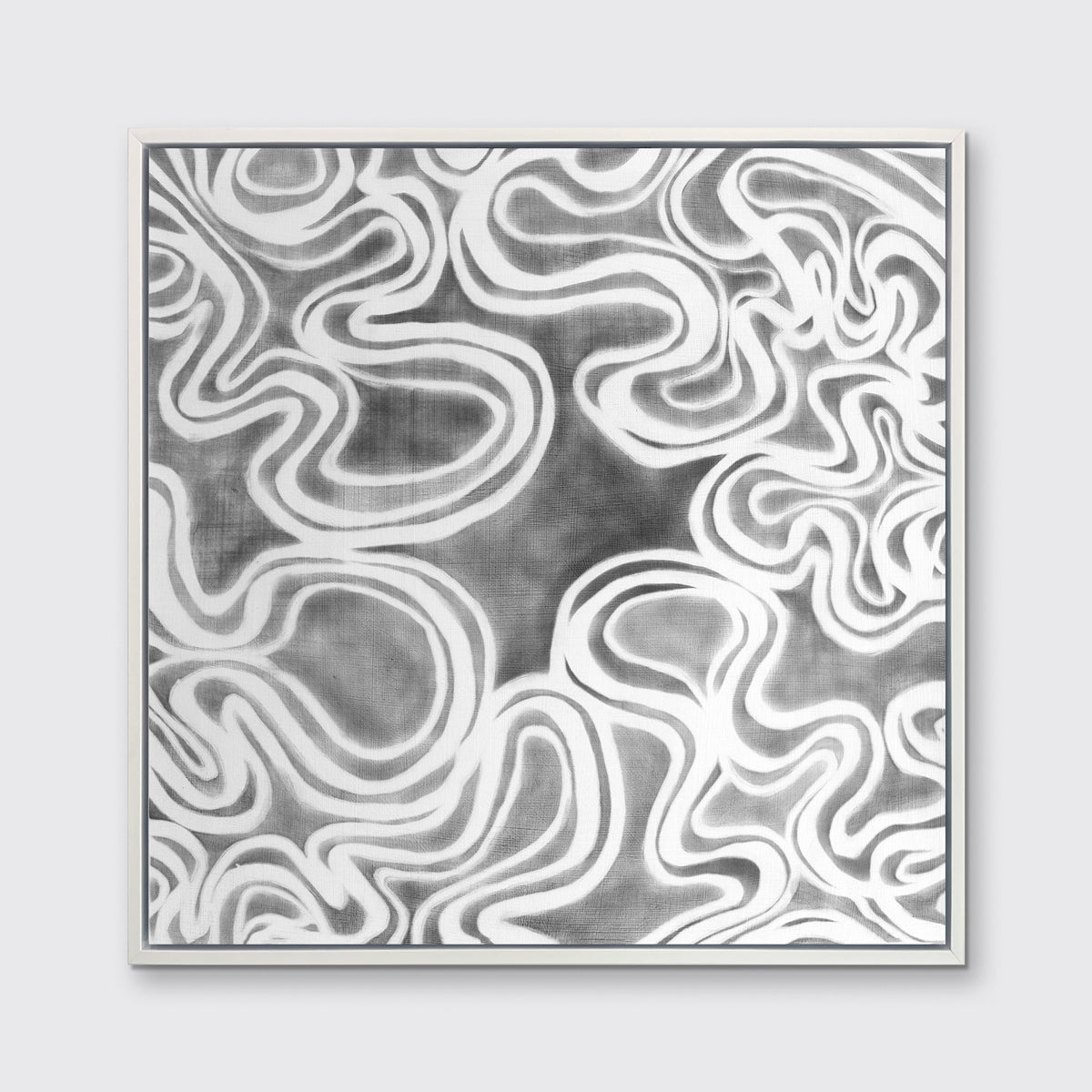 A grey and white abstract print in a white floater frame hangs on a white wall.