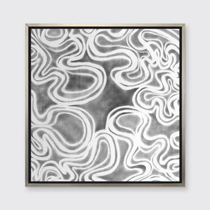 A grey and white abstract print in a silver floater frame hangs on a white wall.