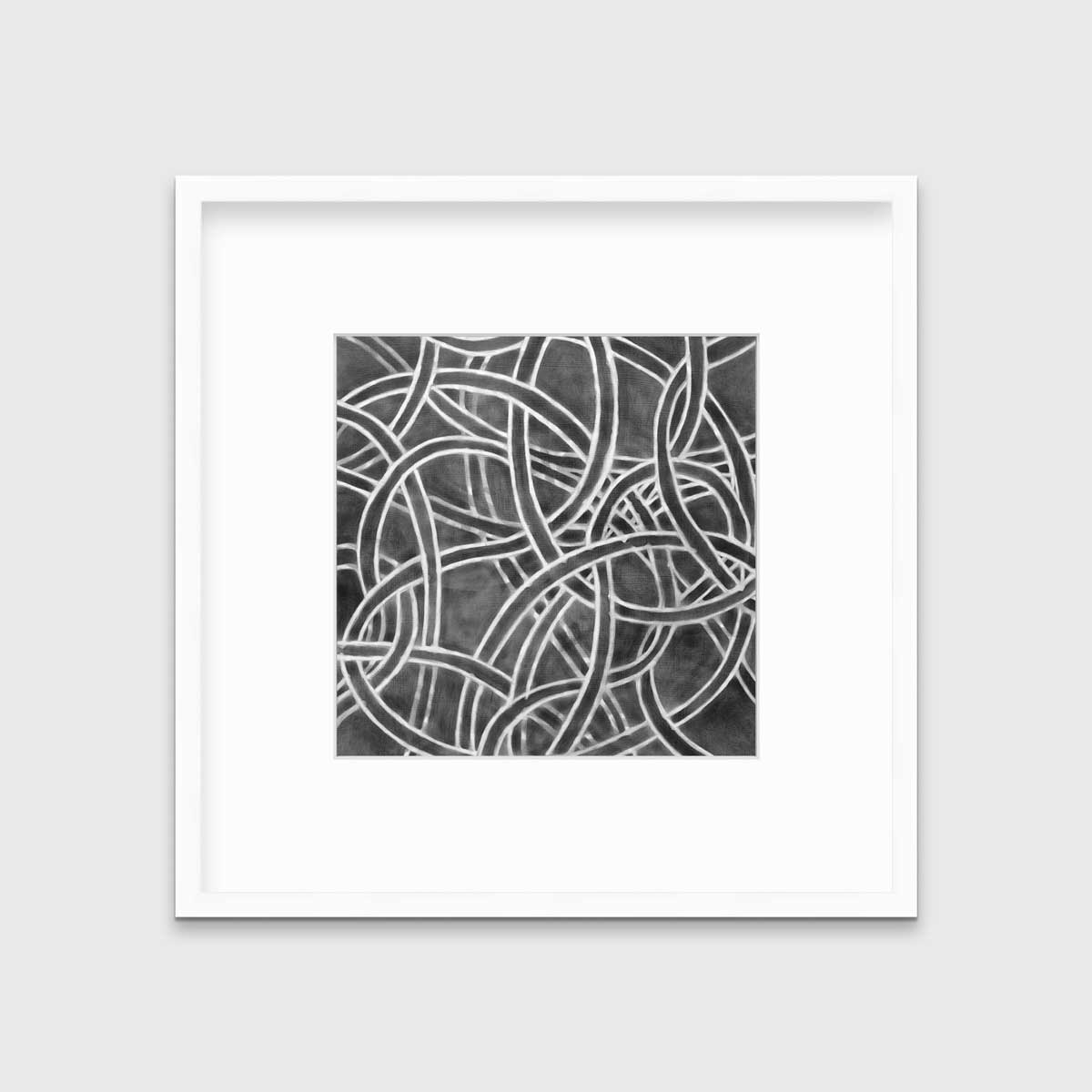 A dark grey and white abstract print in a white frame with a mat hangs on a white wall.