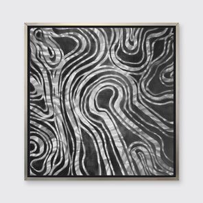 A dark grey and white abstract print in a silver floater frame hangs on a white wall.