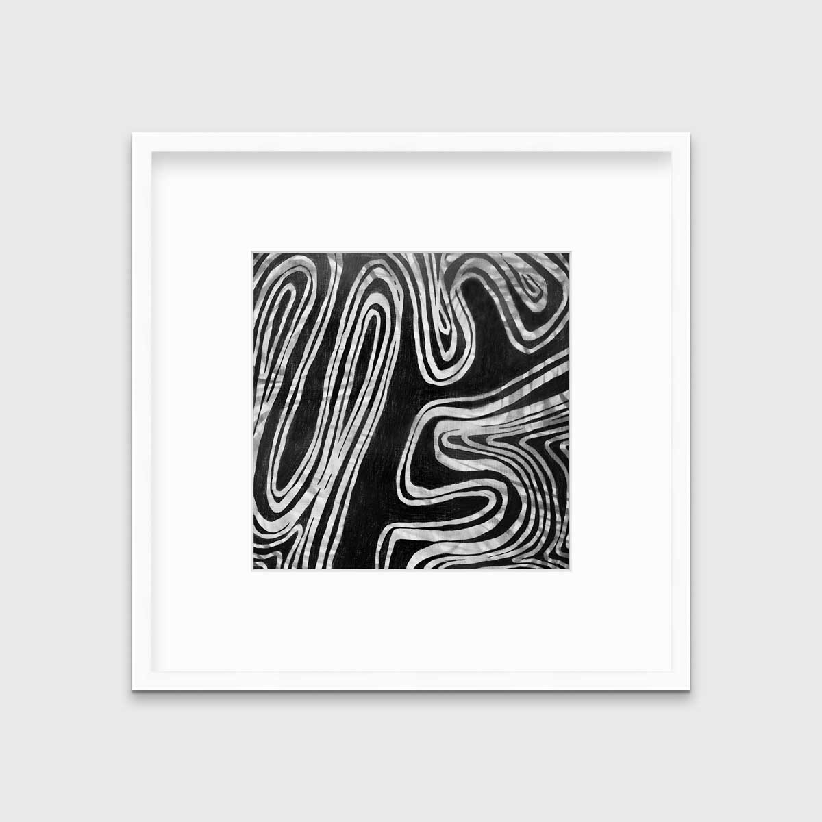 A black and white abstract print in a white frame with a mat hangs on a white wall.