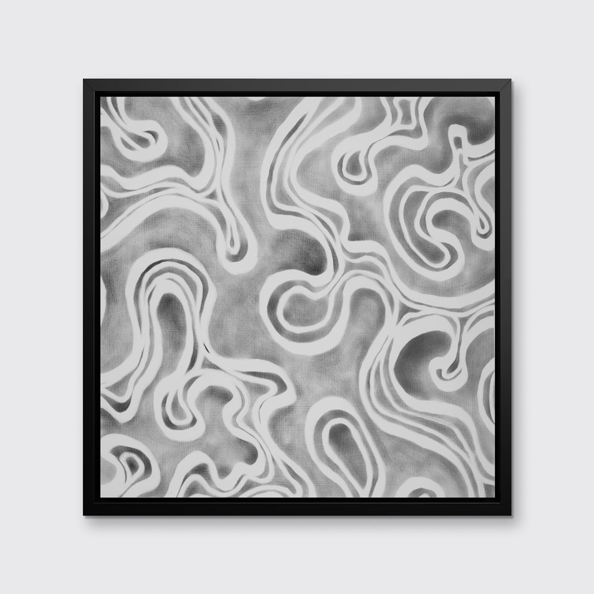 A grey and white abstract print in a black floater frame hangs on a white wall.