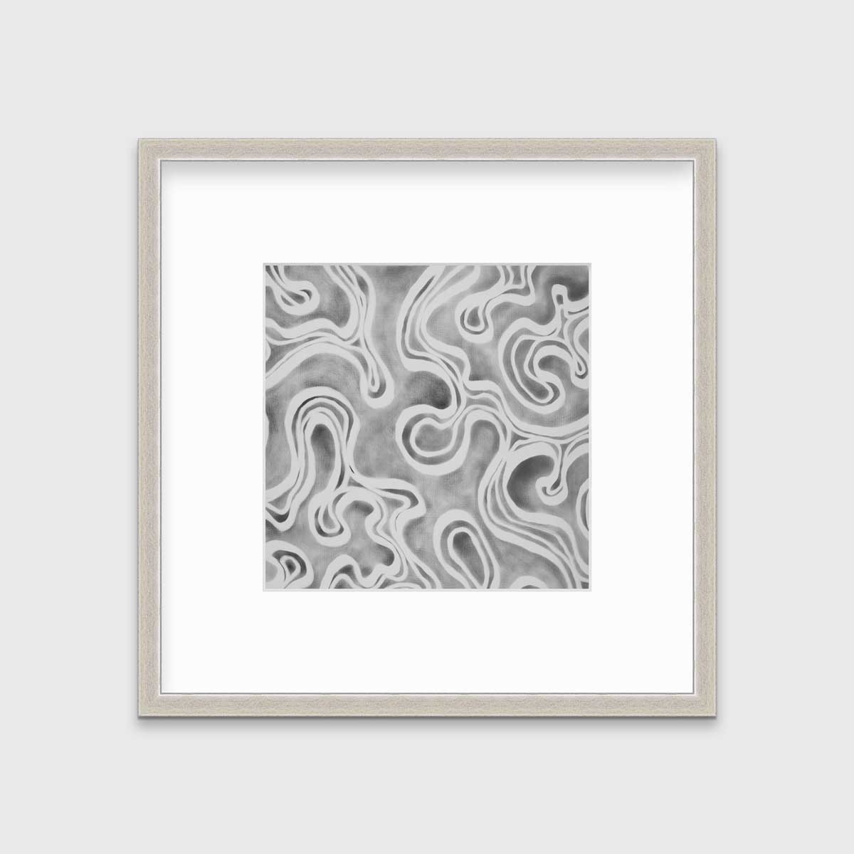 A grey and white abstract print in a silver frame with a mat hangs on a white wall.