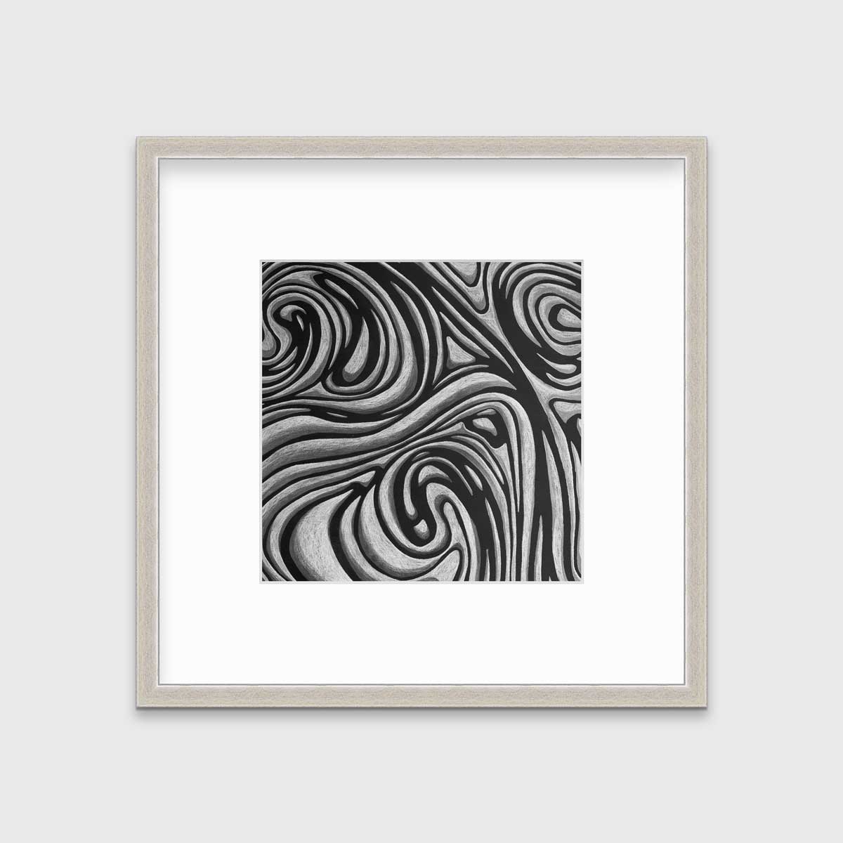 A black and grey abstract print in a silver frame with a mat hangs on a white wall.