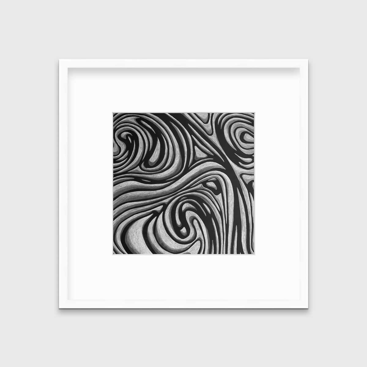 A black and grey abstract print in a white frame with a mat hangs on a white wall.