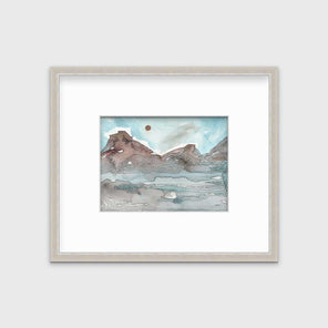 A light blue, brown and black abstract landscape illustration print in a silver frame with a mat hangs on a white wall.