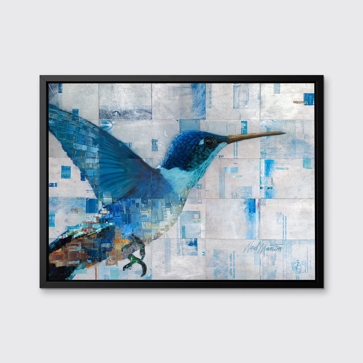 A blue and silver geometric abstract print of a hummingbird in a black floater frame hangs on a white wall.