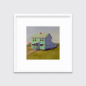 A seafoam green, blue and chartruse contemporary house print in a white frame with a mat hangs on a white wall.